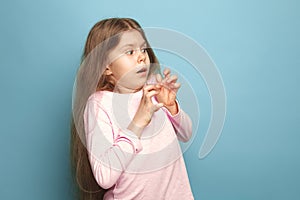 The fear. Teen girl on a blue background. Facial expressions and people emotions concept