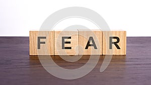 fear written in wooden cubes. conceptual word collected of of wooden elements with the letters. stock image, brown