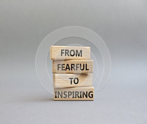 From Fearful to Inspiring symbol. Concept words From Fearful to Inspiring on wooden blocks. Beautiful grey background. Business