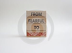 From Fearful to Inspiring symbol. Concept words From Fearful to Inspiring on wooden blocks. Beautiful white background. Business