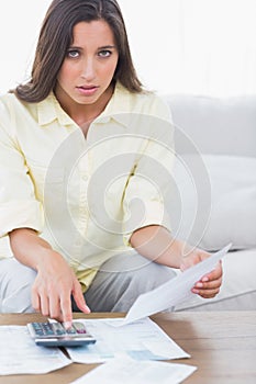 Fearful woman doing her accounts