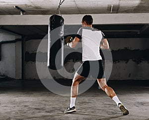 Fearles MMA Fighter practicing his punch on a punching bag