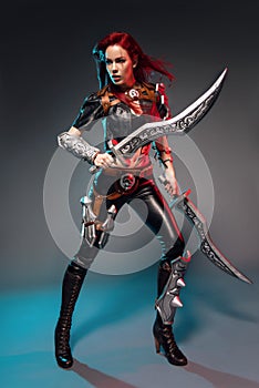 Fearless redhead warrior woman in leather costume with swords