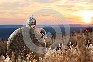 Fearless young Spartan warrior posing in the field