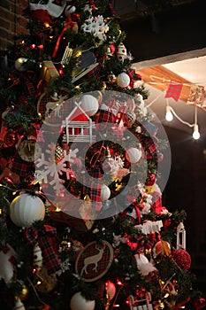 Feast of Christmas. Beautifully decorated house with a Christmas tree ipodarkami underneath