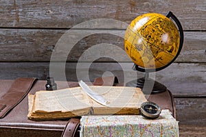 Feather on book beside inkwell.