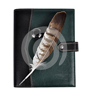 Feather with ink bottle and notebook