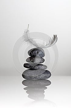 Feather over zen stones