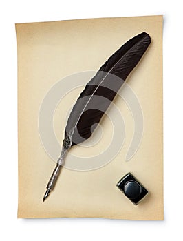 Feather quill and inkwell on an old paper