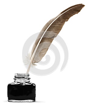 Feather quill pen and glass inkwell isolated on a