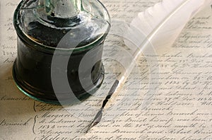 Feather quill pen and inkwell
