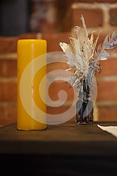 Feather quill pens candle and old paper on wooden desk. Vintage.