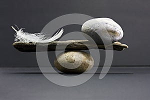 Feather and stone balance photo