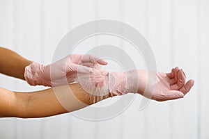 Feather to female hand on white background. Concept of lightness easing and cleanliness. Hand Skin Care. Woman Hands