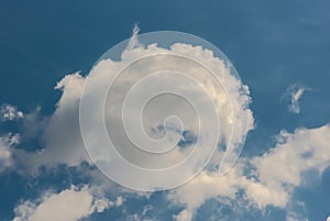 A feathery cloud in a blue June sky.