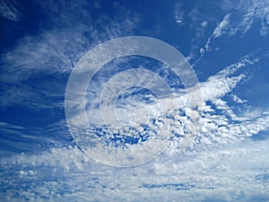 FEATHERY CLOUDS AGAINST BLUE SKY