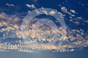 Feathery clouds of various shapes located on the blue sky