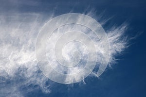 Feathery white wispy cloud in a blue sky