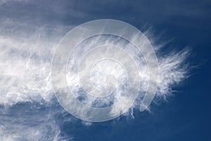 Feathery white wispy cloud in a blue sky