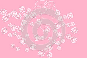 Features of a woman`s face on a pink background in flowers.
