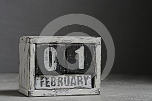 February 01 on wooden calendar, on dark gray background