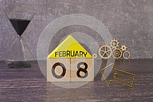 February 08. 8th day of the month, wooden calendar isolated on a white background with shadow