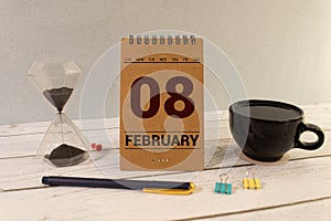 February 08. 8th day of the month, wooden calendar isolated on a white background with shadow