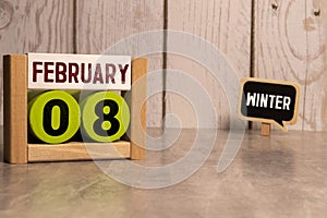 February 08. 8th day of the month, wooden calendar isolated on a white background with shadow