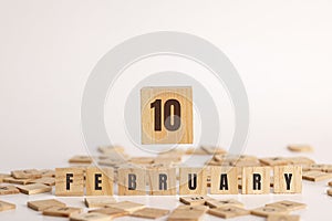 February 10 displayed wooden letter blocks on white background