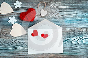 February 14, background with hearts and an envelope on a wooden background.