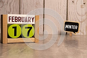 February 17th. February 17 wooden cube calendar with blur objects on background