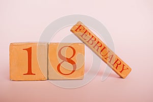 february 18th. Day 18 of month, handmade wood calendar  on modern color background. winter month, day of the year concept