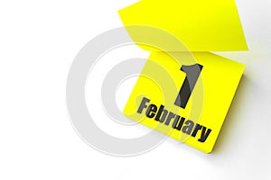 February 1st . Day 1 of month, Calendar date. Close-Up Blank Yellow paper reminder sticky note on White Background. Winter month,