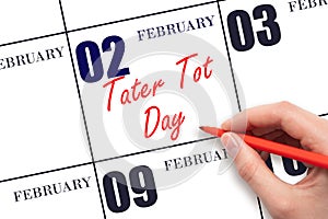 February 2. Hand writing text Tater Tot Day on calendar date. Save the date.