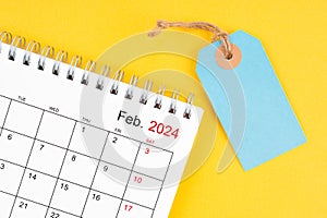 February 2024 desk calendar with blank price tag on yellow