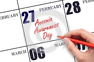 February 27. Hand writing text Anosmia Awareness Day on calendar date. Save the date.