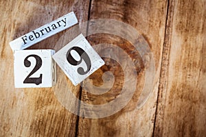 February 29th. Day 29 of February month, white calendar blocks on vintage wooden table background. Winter time. Empty space for