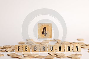 February 4 displayed wooden letter blocks on white background