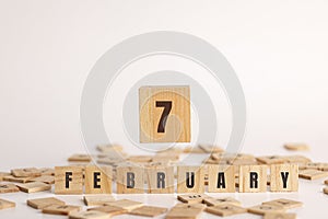 February  7 displayed wooden letter blocks on white background