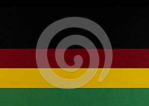 February Black History Month. Brown wooden hand on Paper geometric black, red, yellow, green background. Copy space