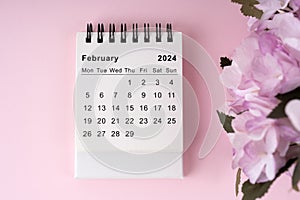 February 2024 desk calendar on pink background