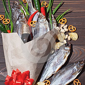 February 23. Gift for men. A bouquet of dry fish, chips, pistachios, green onions, chili peppers. Decorated with a red bow. Men`s