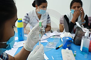 February 20, 2021, Kishanganj, Bihar, India. A nursing staff drawing covishield vaccine in a syringe preparing for