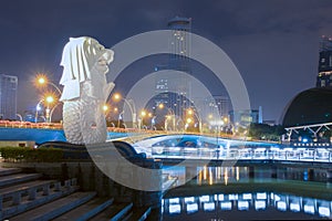 25 February 2018 Merlion statue fountain in Merlion Park at night time with cityscape of singapore in background.Merlion is a