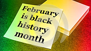 February is the month of black history  written on a stack of paper  tinted gradient background green  yellow  red