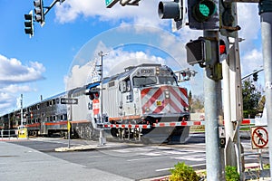 February 10, 2019 Sunnyvale / CA / USA - Caltrain crossing at a street junction near a residential neighborhood in south San