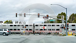February 25, 2019 Sunnyvale / CA / USA - Caltrain crossing at a street junction near a residential neighborhood in south San