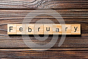 February word written on wood block. February text on wooden table for your desing, Top view concept