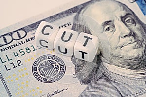 FED, Federal Reserve with interest rate cut concept, small cube block with alphabet building the word CUT next to Federal Reserve photo