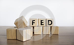 FED symbol. Wooden cubes with word `FED` on a beautiful wooden table, white background. Business and FED concept, copy space